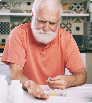 old man taking pill
