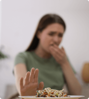 vrouw duwt met haar hand een bord eten weg